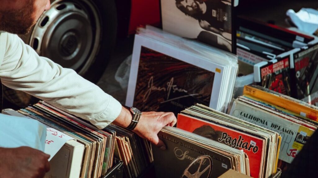 person holding vinyl records